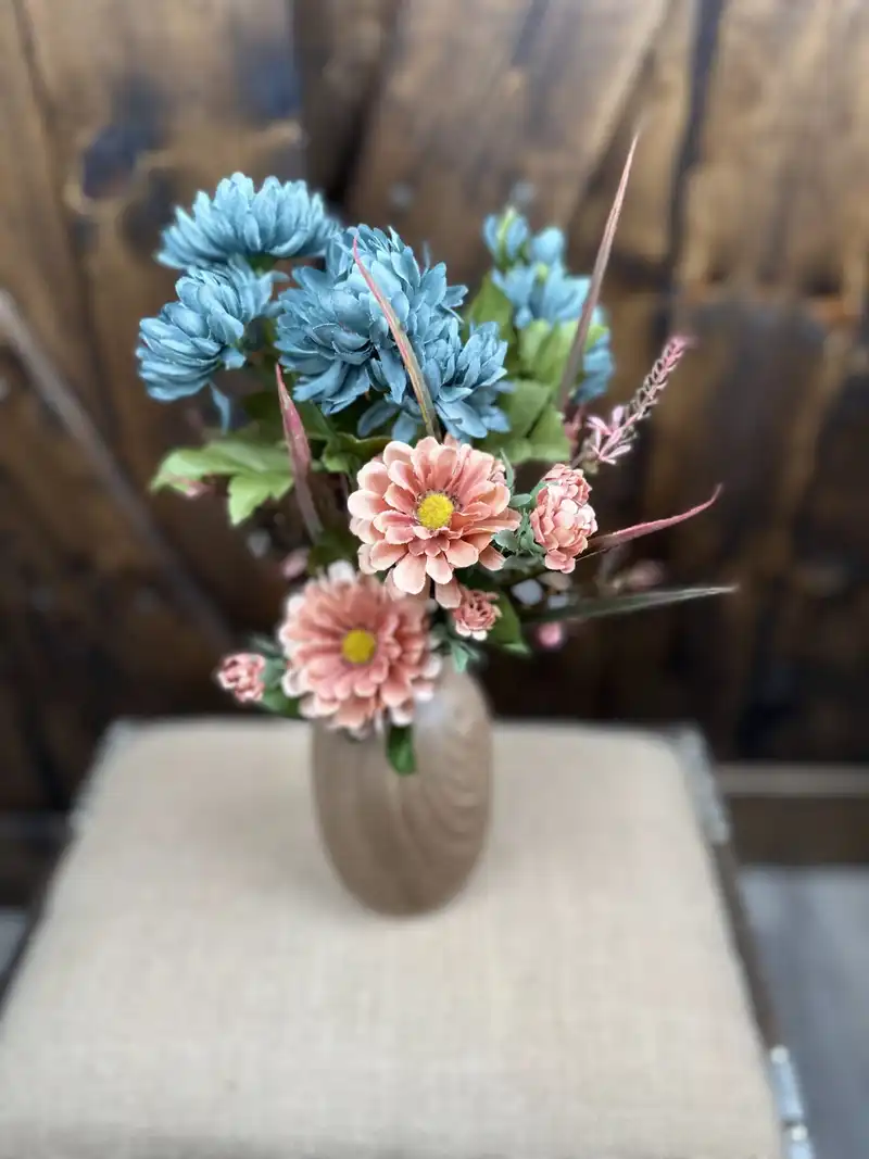 Dusty blue mums and pink dahlias in a taupe ceramic vase