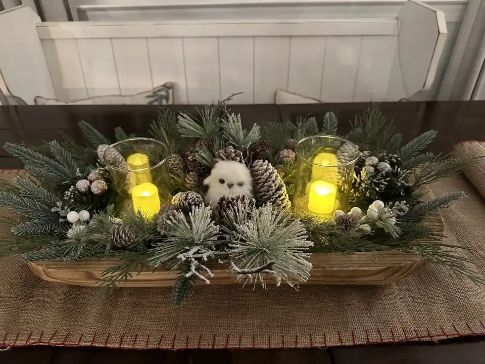 Christmas log centerpiece with pine, owls, pinecones and flickering candles